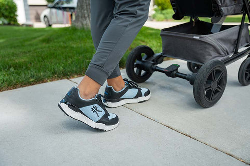 KURU Footwear Womens QUANTUM in color JetBlack-MistyBlue walking behind a stroller.