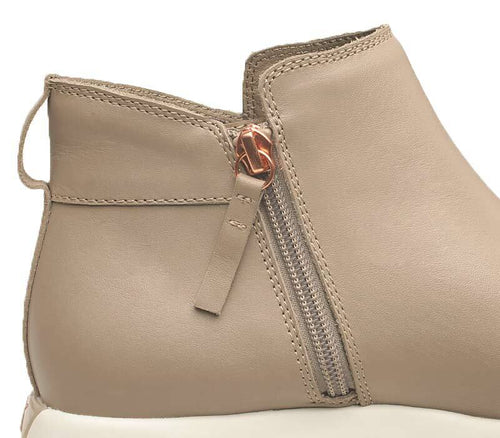 Close-up of the zipper on the KURU Footwear TEMPO Women's Ankle Boot in TaupeGray-RoseGold