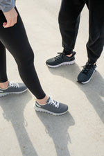 Top-down view of two individuals wearing FLEX VIA sneakers by KURU Footwear, showcasing two different color variants