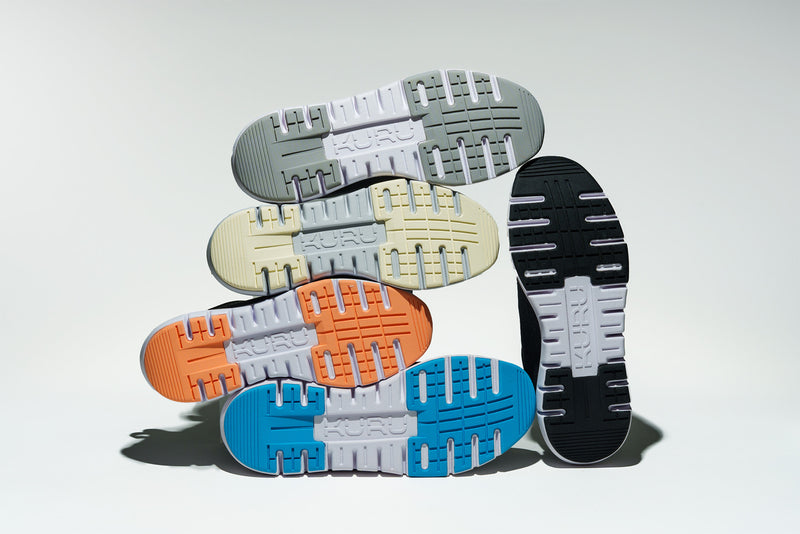 Display of KURU Footwear FLEX Via sneakers in all color variants, showcasing the soles of each color