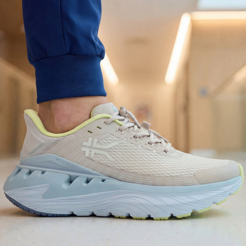 Beige shoe with blue sole worn indoors