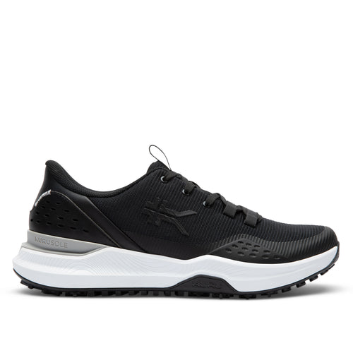Black sneaker with white sole on a light gray background