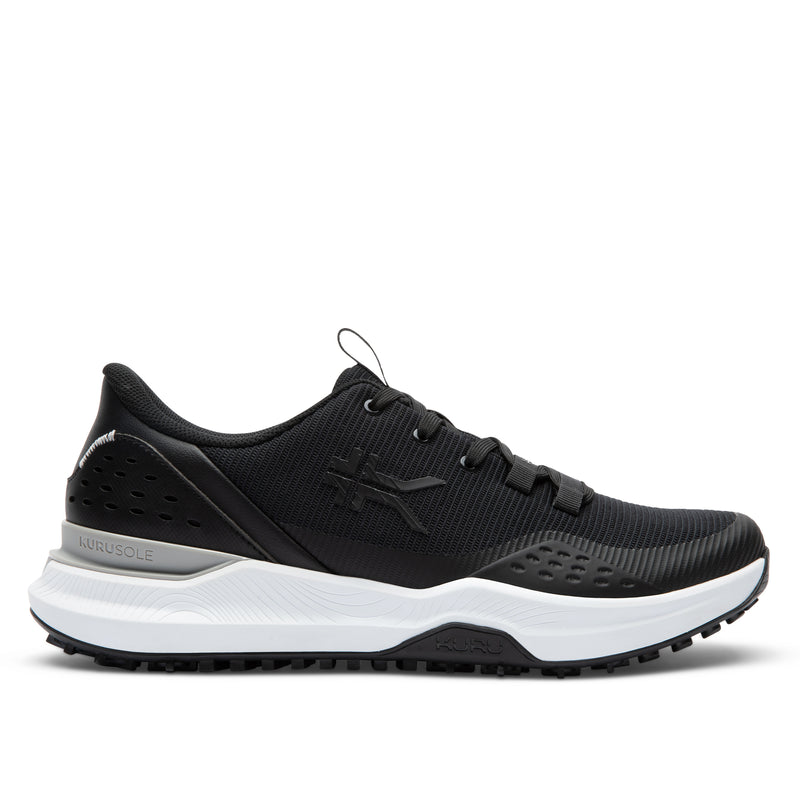 Black sneaker with white sole on a light gray background