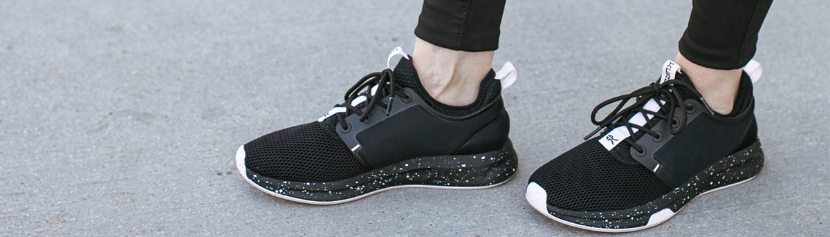 Woman wearing a pair of Black ATOMs