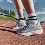 Close-up of the KURU ATOM 2 Women's Athletic Sneaker in Mist Blue-Bright White on a running track.