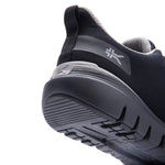 Close-up of the heel cup and KURUSOLE on the KURU FLEX Via Waterproof Unisex Sneaker in Jet Black-Tungsten Gray.
