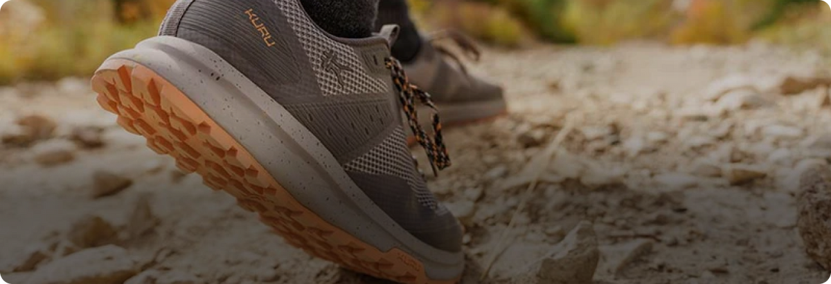 Man walking on rocky trail, wearing KURU Footwear's ATOM Trail shoes 