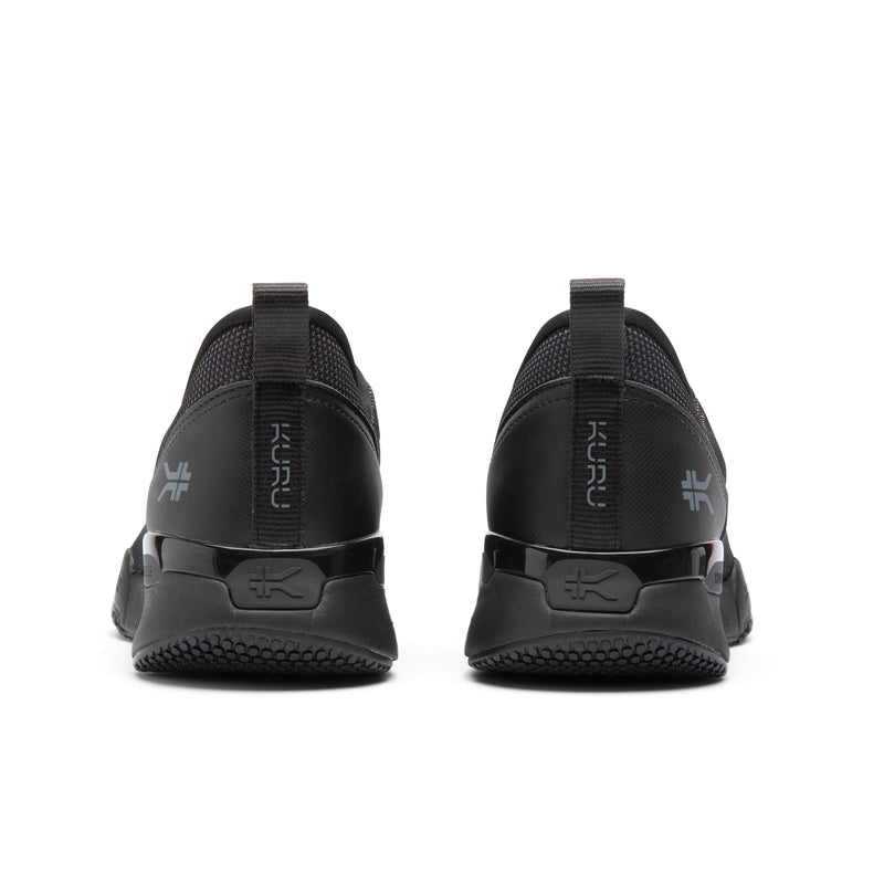 Black athletic shoes with 'Kuru' branding on a white background