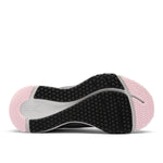 Close-up of a pink and black athletic shoe sole on a white background