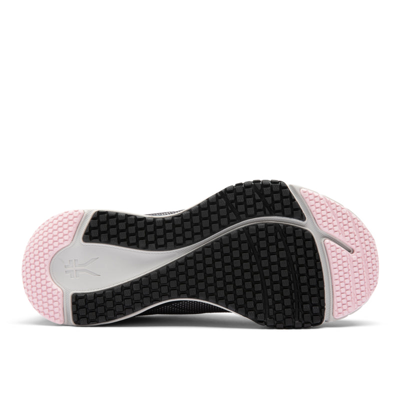 Close-up of a pink and black athletic shoe sole on a white background