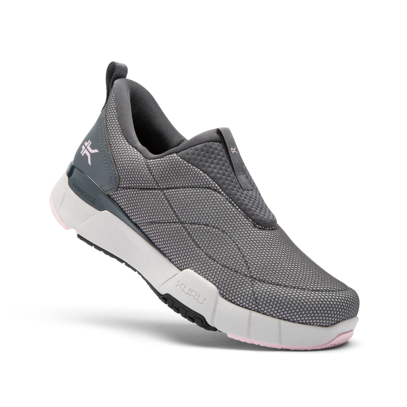 Gray slip-on shoe with pink sole on a white background