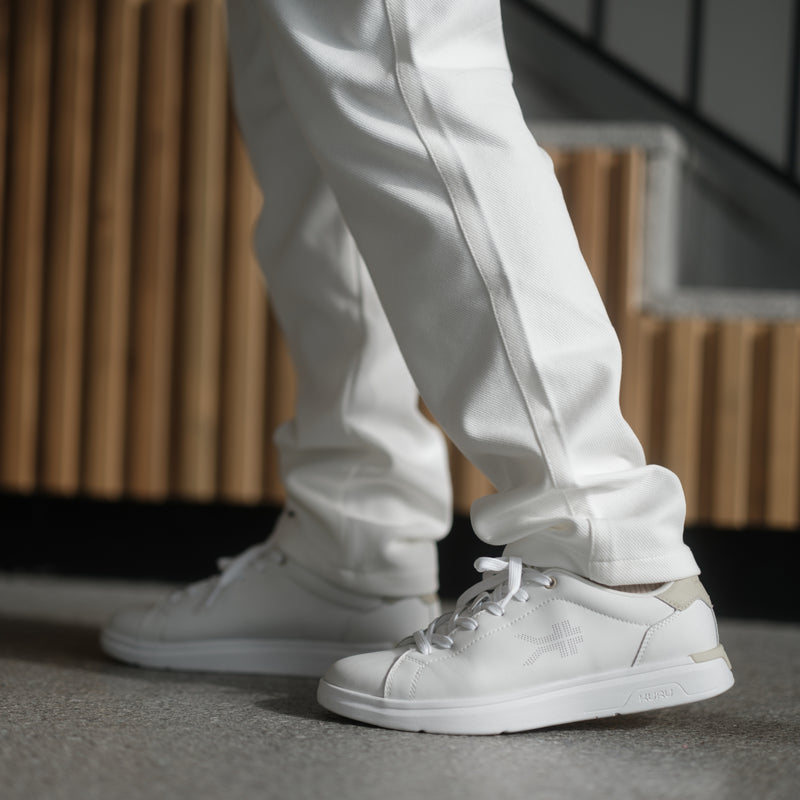 White sneakers and pants on a neutral background